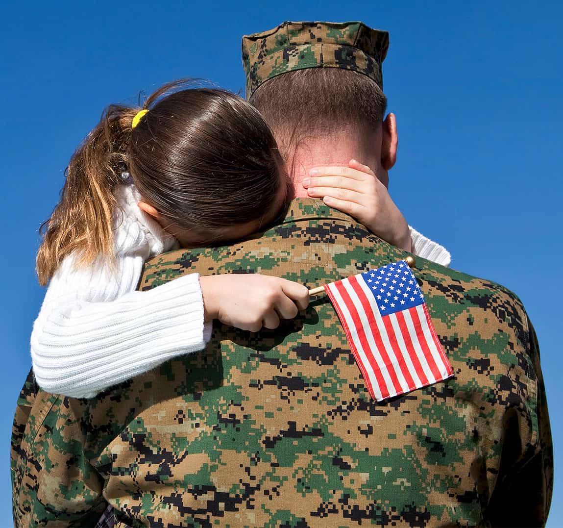 Military Father Hugging His Daughter With An American Flag